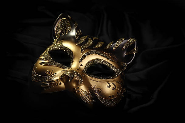 gold cat mask on black background